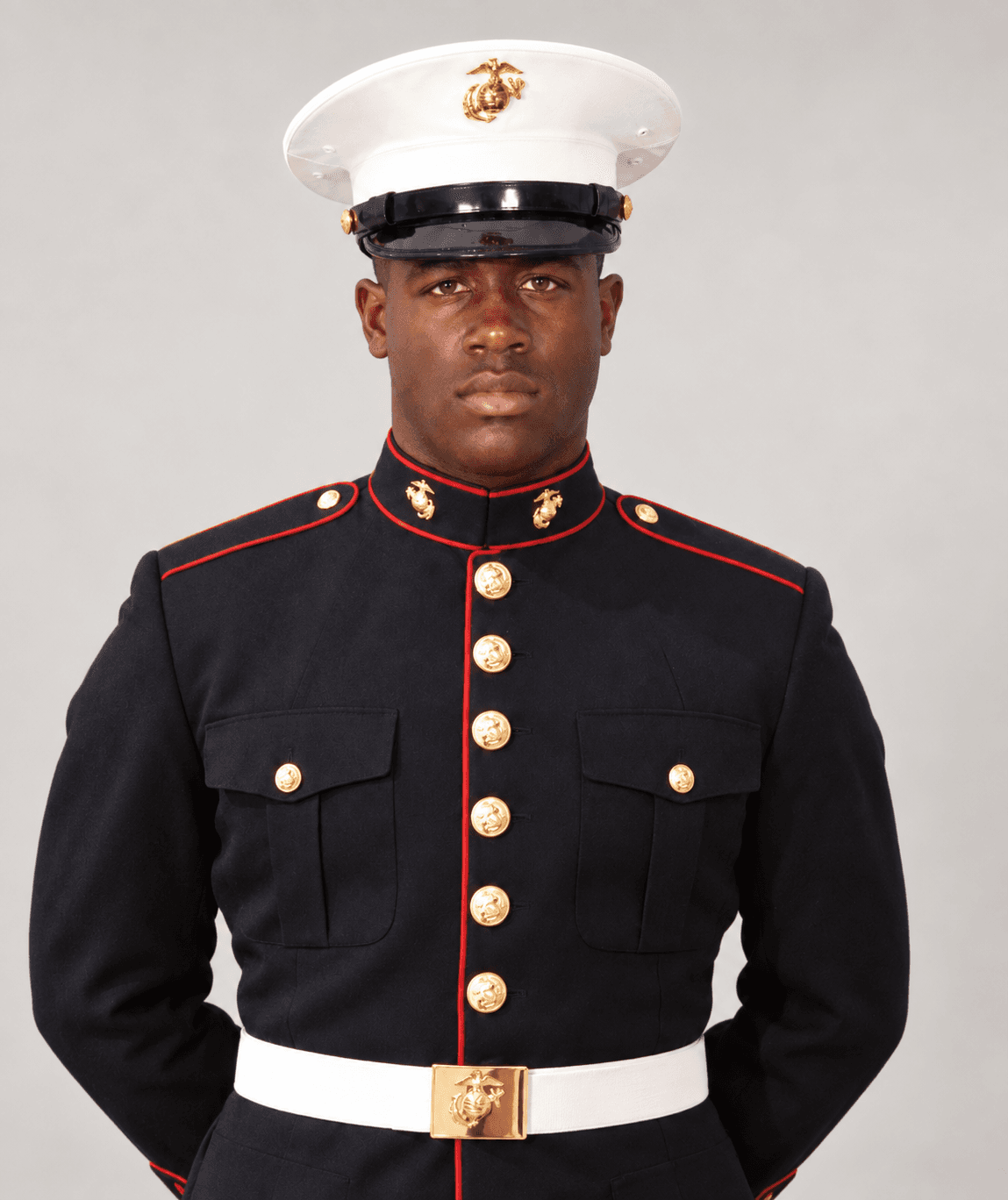 Black man in a U.S. Marine Corps Dress Blue uniform with a white cover.